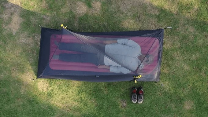 Overhead view of a person inside the ROAMER mesh inner tent