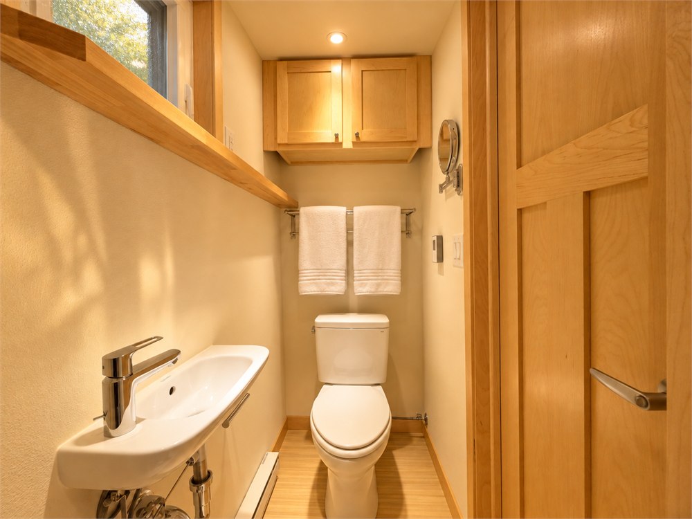 Compact bathroom with toilet and small wall-mounted sink