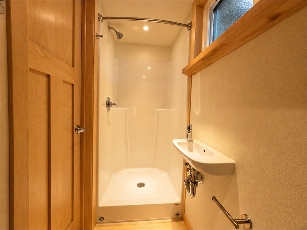 Shower in the enclosed tiny house bathroom