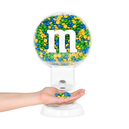 A hand receiving chocolate candy from the touchless dispenser