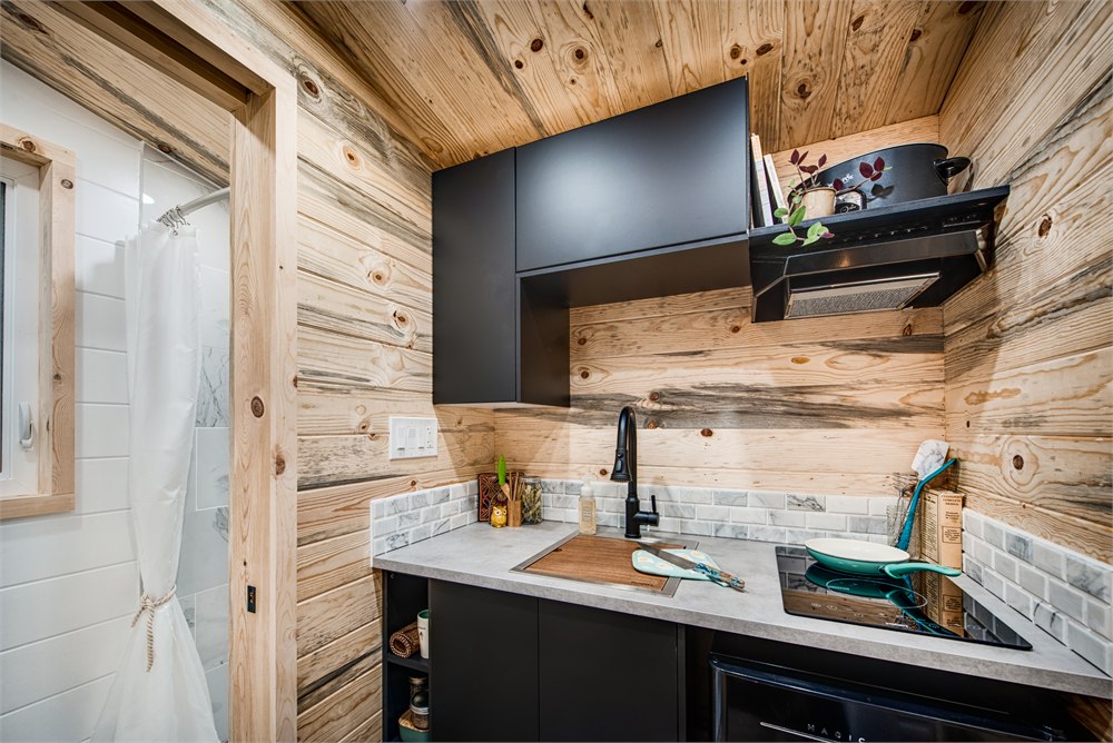 Compact kitchen beside the bathroom entrance