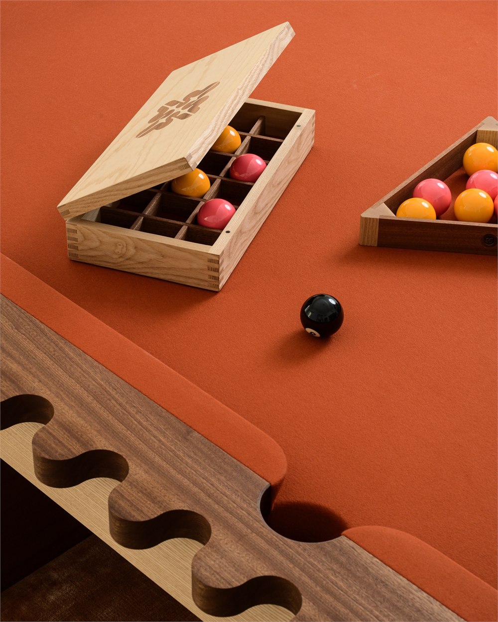 Wooden ball box and triangle on the orange pool surface
