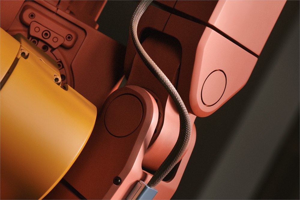 Close-up of Voxel robot cable and articulated salmon-colored arm
