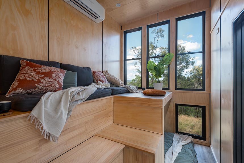 Wildscape tiny house tiered timber lounge and lower sleeping nook