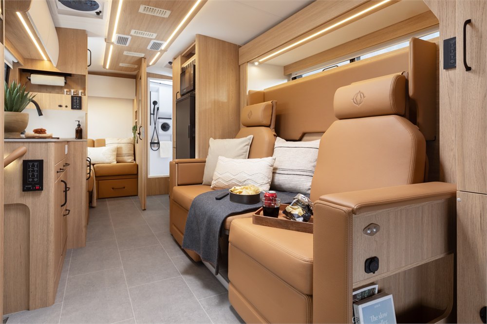 Wonder FX front lounge with two caramel-colored reclining seats and wood cabinetry